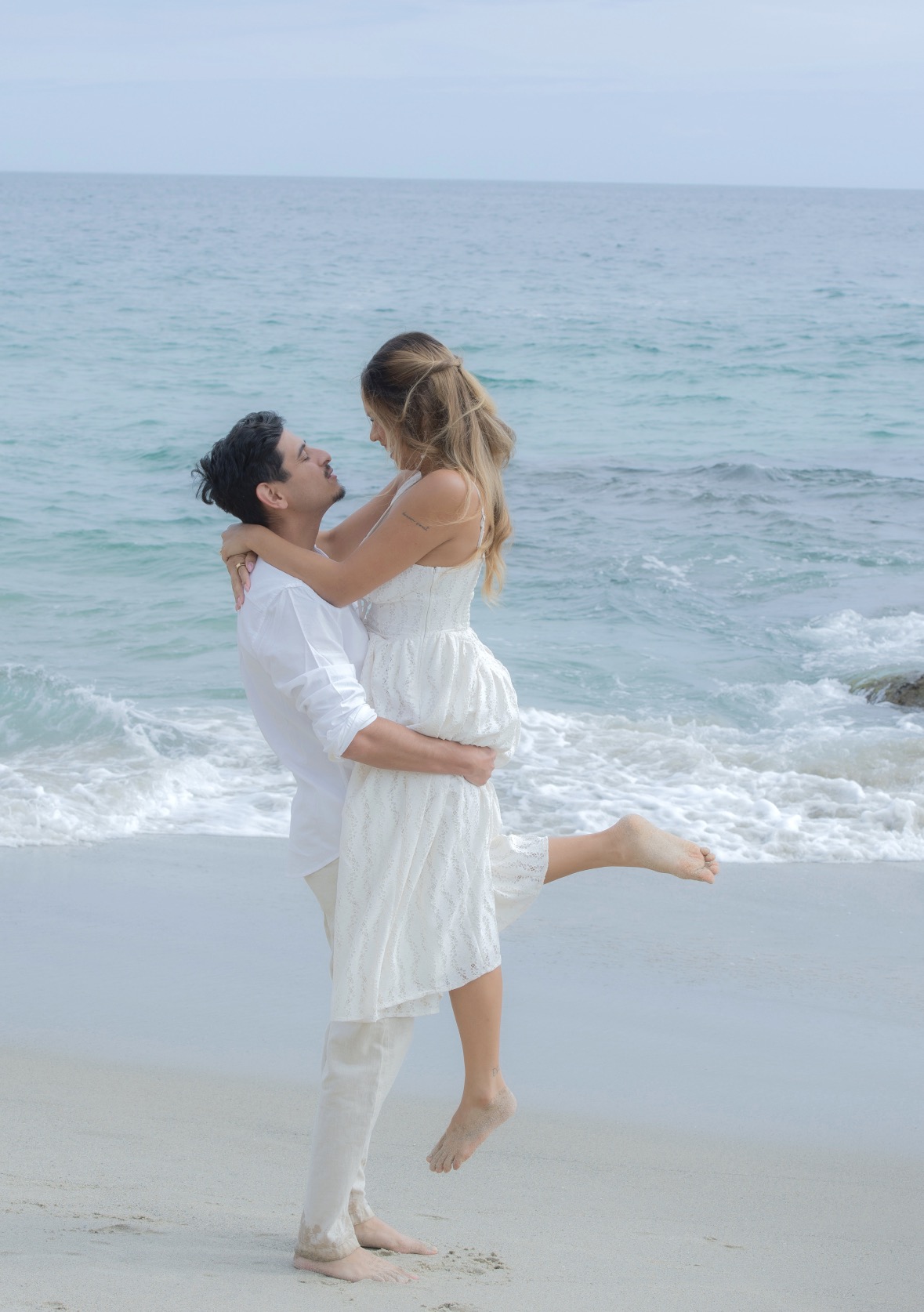 Couple embracing at the shoreline