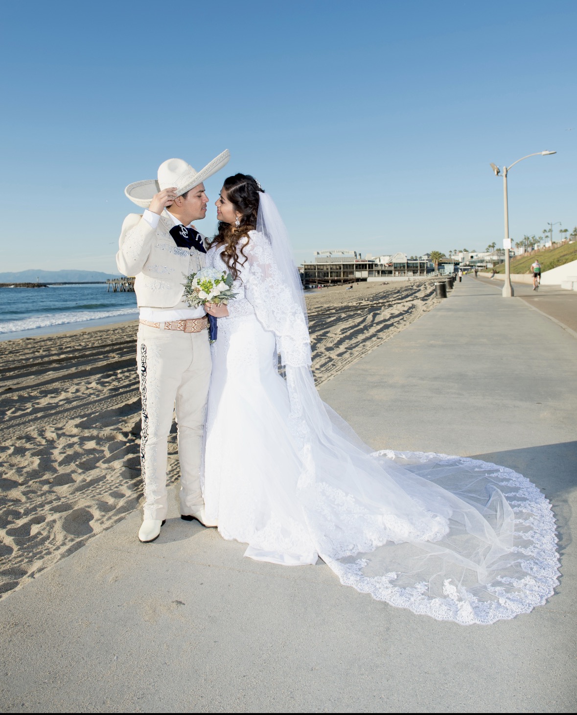 Charro groom and bride on the beach
