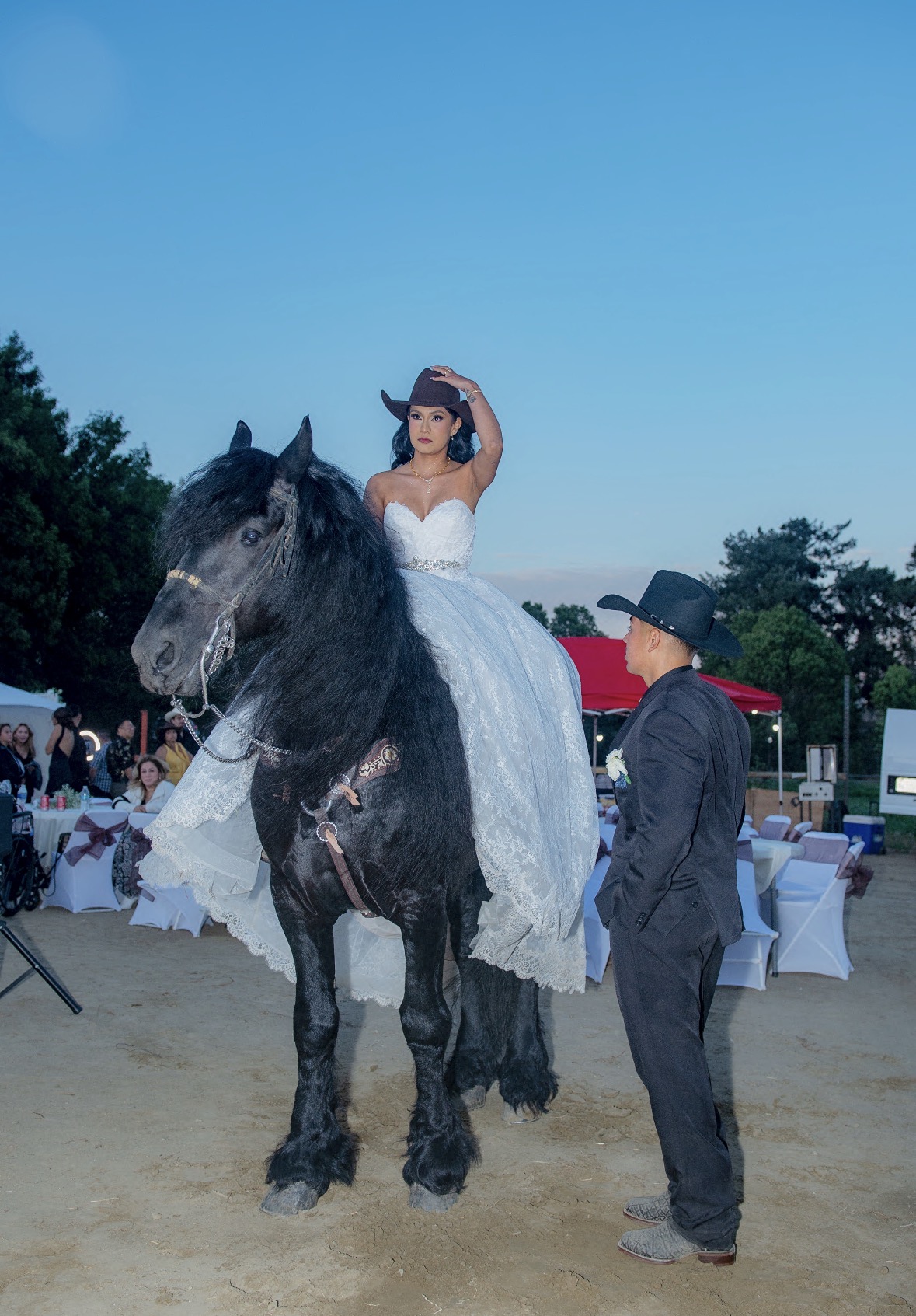 Quinceañera on horseback with a charro escort