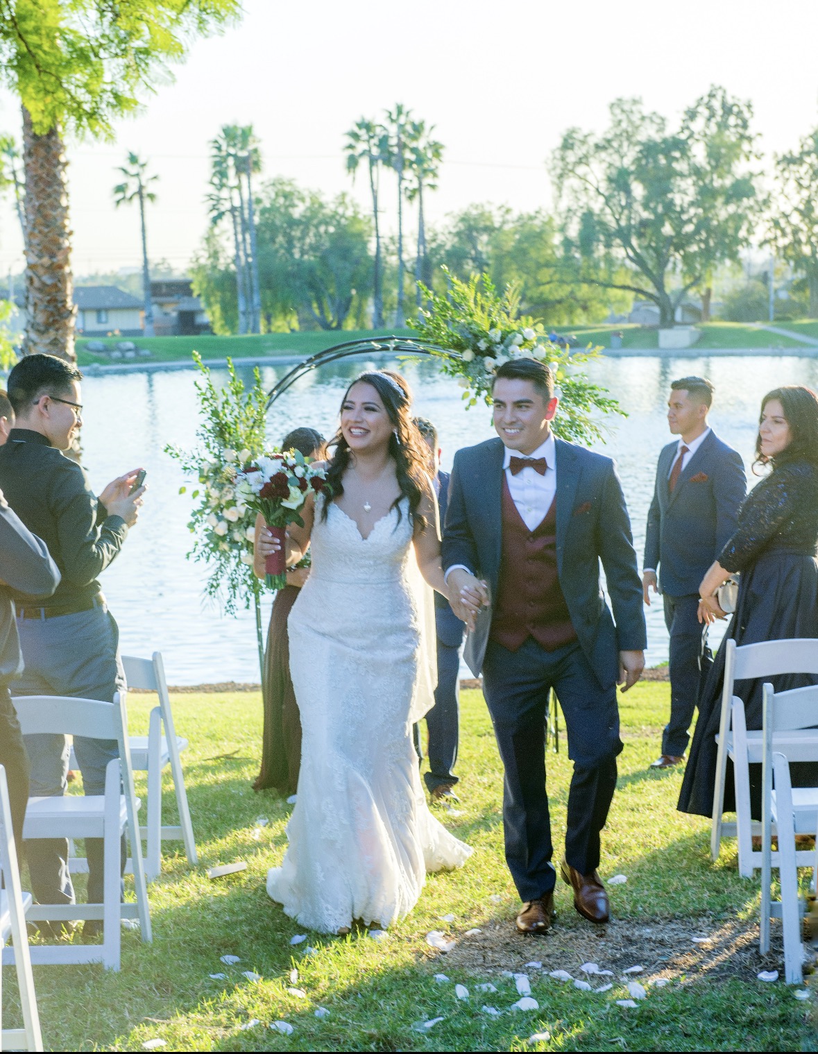 Bride and groom walking down the aisle by the lake