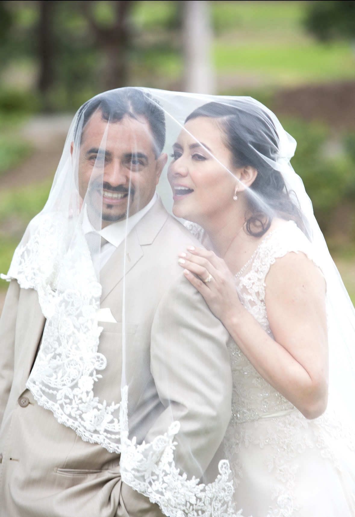 Bride and groom beneath the veil